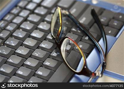 A closeup shot of glasses on a laptop