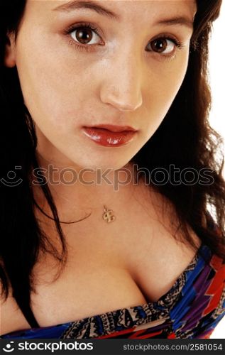 A closeup shot of the face of a young woman with her black hair and redlips, looking into the camera.