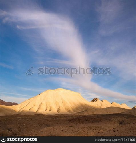 A cloud raises up over sand hills in Death Valley. Rock Formation Death Valley National Park California