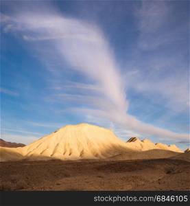 A cloud raises up over sand hills in Death Valley. Rock Formation Death Valley National Park California