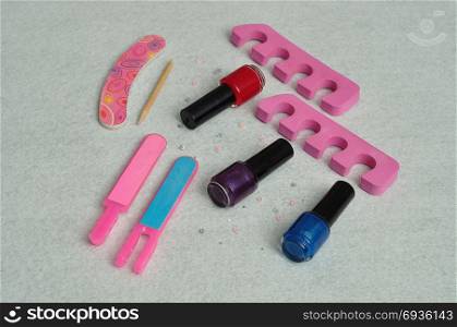 A collection of accessories needed for a manicure or pedigree isolated on plain background