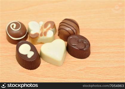 A collection of confectionery isolated on a wooden background