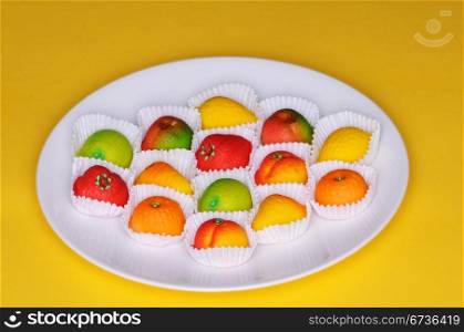 A collection of marzipan fruits on a plate