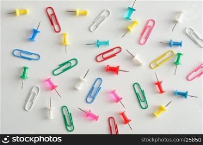 A collection of paper clips and push pins