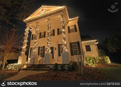 A Colonial House with a lot of Christmas Lights