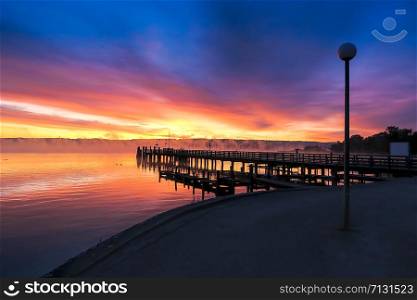 a colorful spectacle at sunrise ammersee, overlooking the eastern shore with Andechs Monastery