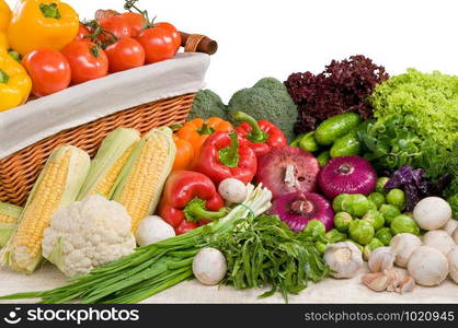 A composition of various vegetable on a table and in a basket