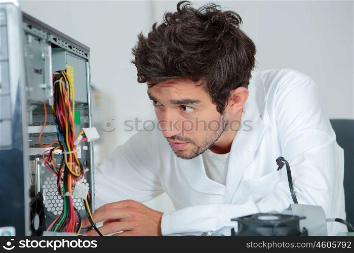a computer repairman looking confused
