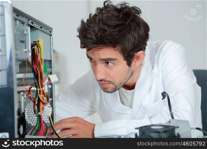 a computer repairman looking confused
