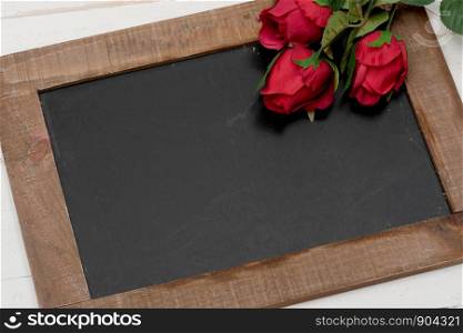 a concept romantic, small chalkboard with three roses
