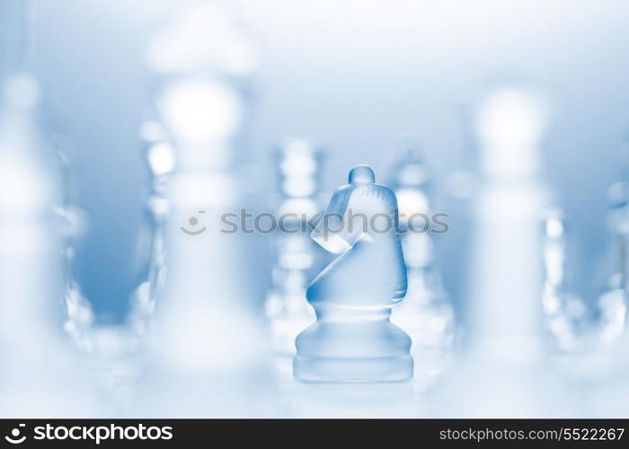 A conceptual photo of a transparent knight on a chessboard making an l-shaped move.