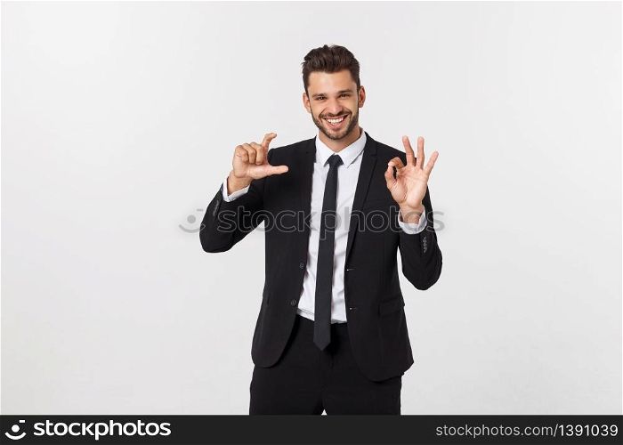 A confident and successful handsome businessman with black suit and mustache. in a suit shows a sign of consent and advises a product or service.. A confident and successful handsome businessman with black suit and mustache. in a suit shows a sign of consent and advises a product or service