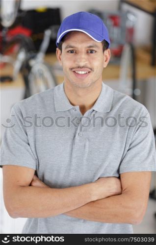 a confident young car mechanic