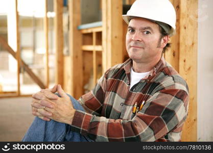 A construciton worker on the jobsite with a proud expression. Authentic construction worker on actual construction site.