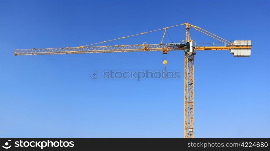 A construction crane on a blue sky background