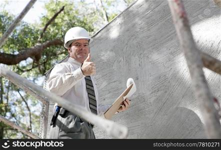 A construction inspector giving a thumbsup to show the building passed inspection.