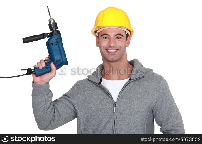 A construction worker holding a drill.
