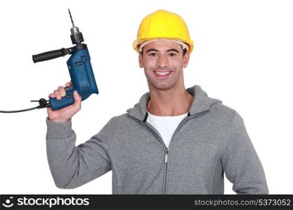 A construction worker holding a drill.