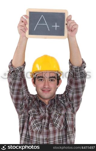 A construction worker holding a slate.