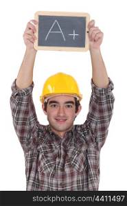 A construction worker holding a slate.