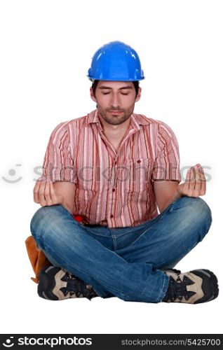 A construction worker in a yoga position.
