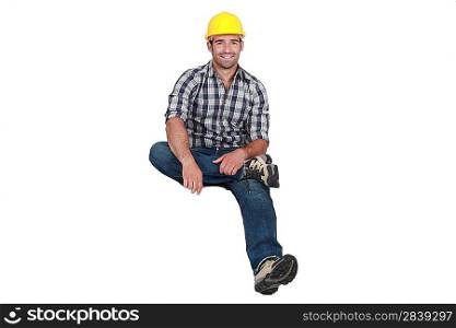 A construction worker levitating.