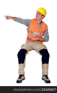 A construction worker pointing at a direction.