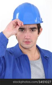 A construction worker saluting.