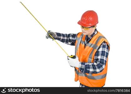 A construction worker, wearing his personal protection wear, looking at a measurement on a tape measure. Clipping path included