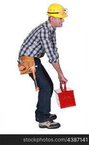 A construction worker with a heavy toolbox.