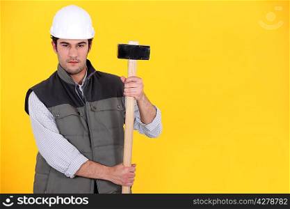 A construction worker with a sledgehammer.