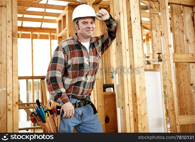 A construction worker with his tools on the jobsite. Authentic construction worker on actual construction site.