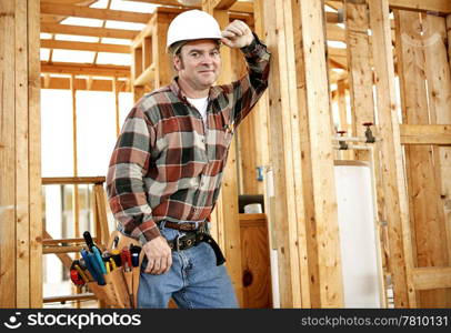 A construction worker with his tools on the jobsite. Authentic construction worker on actual construction site.