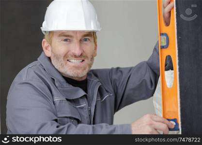 a construction worker with level