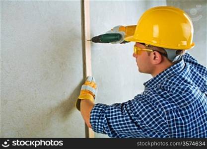 a contractor working with electrical screwdriwer