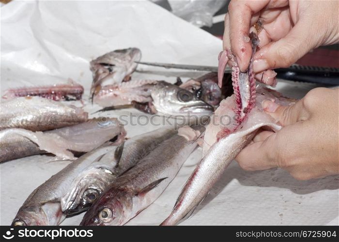 a cook preparing fish for cooking