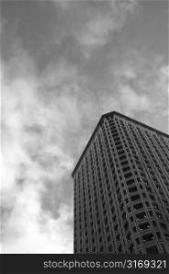 A corporate building with dark clouds (in black and white)