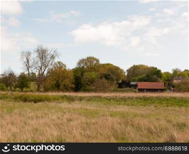 a countryside scene with a barn outside in the spring