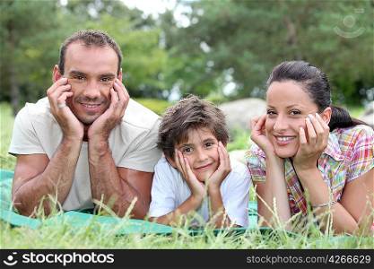 a couple and their son in the park