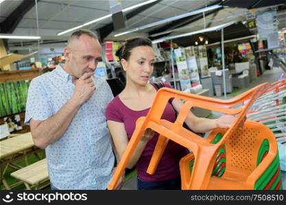 a couple buying plastic chairs