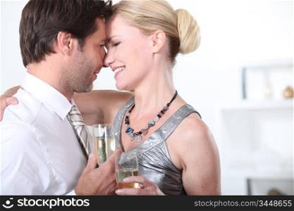 A couple celebrating with a glass of champagne