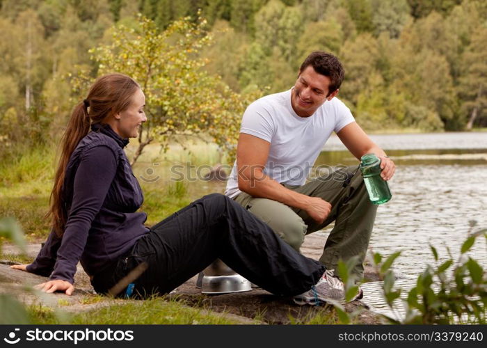 A couple cooking and making food outdoors on a camping trip