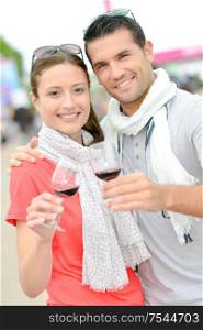 a couple drinking wine outdoors