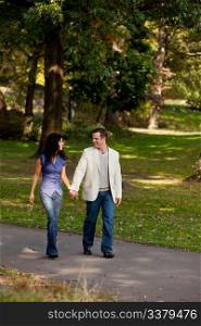 A couple happy and walking in a park