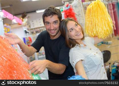a couple holding a pompon