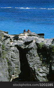 A couple holidaying on the rocks, Atwood bay beach, Bermuda