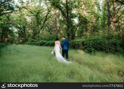 A couple in love a guy and a girl on a walk in the forest belt