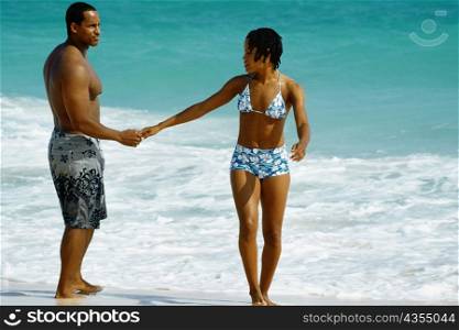 A couple in swimsuit enjoying on Horse-shoe Bay beach, Bermuda