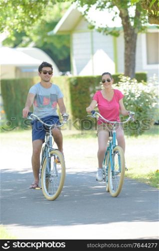 a couple is cycling outdoors