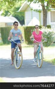 a couple is cycling outdoors